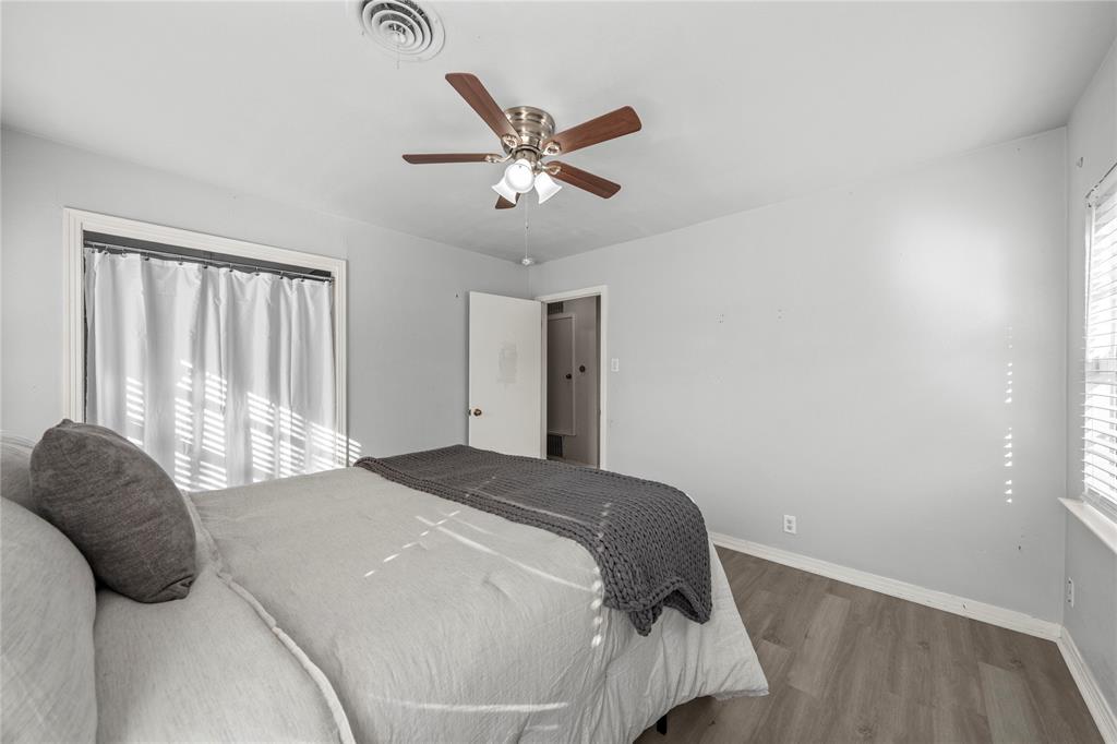 901 North Main Street West, TX 76691 - Photo 18 of 32 a bedroom with a large bed and a chandelier