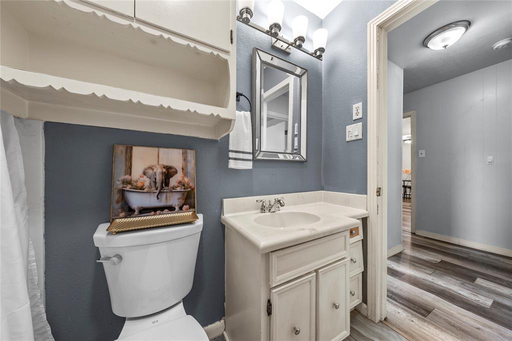 901 North Main Street West, TX 76691 - Photo 20 of 32 a bathroom with a toilet a sink and a mirror