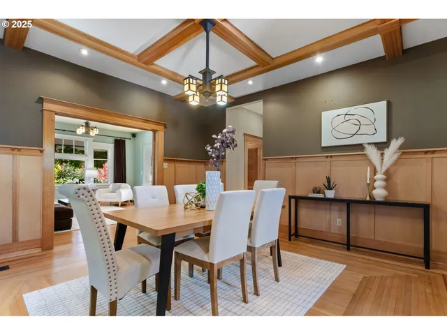 a view of a dining room with furniture and chandelier