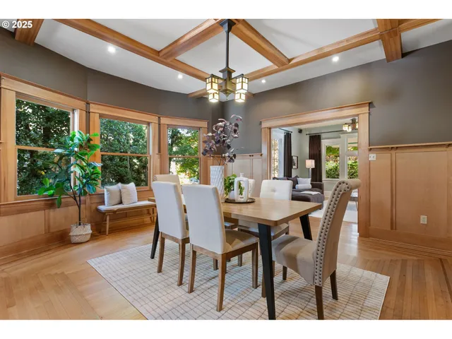 a dining room with furniture a chandelier and wooden floor