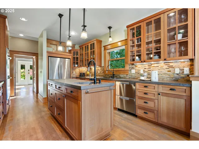 a kitchen with stainless steel appliances granite countertop a stove and a sink