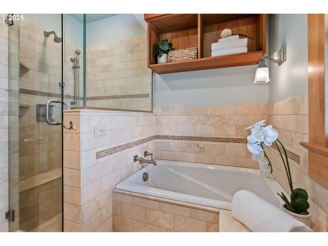 a bathroom with a bathtub and a shower
