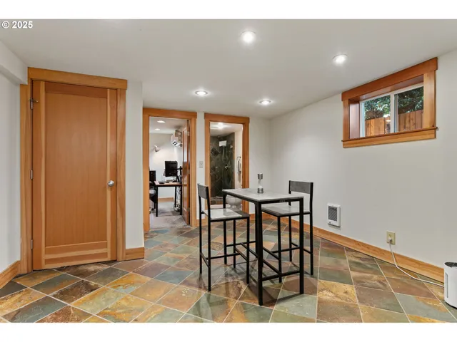 a view of a dining room with furniture and a potted plant