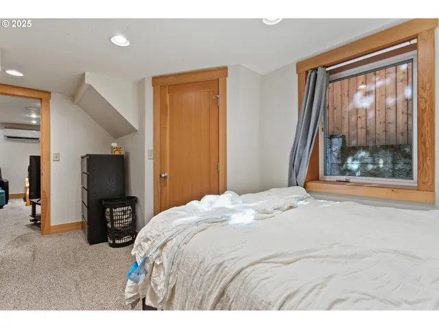 a spacious bedroom with a bed and a window