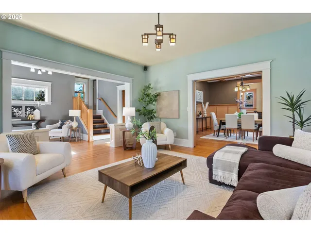 a living room with furniture and a chandelier