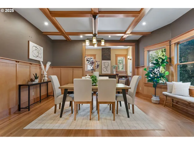 a dining room with furniture a chandelier and wooden floor
