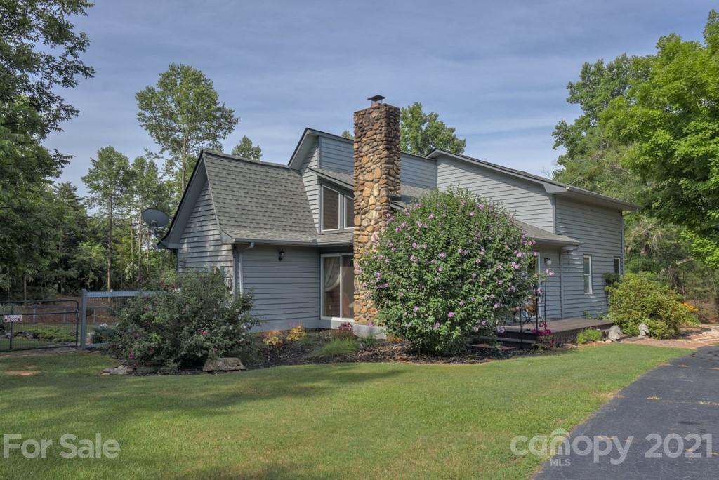 125 Mountainview Road Landrum, SC 29356 - Photo 2 of 48 a front view of a house with garden