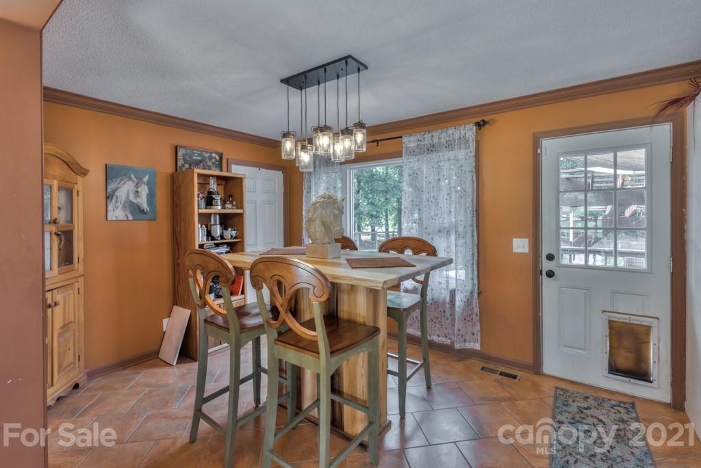 125 Mountainview Road Landrum, SC 29356 - Photo 13 of 48 a view of a dining room with furniture and chandelier