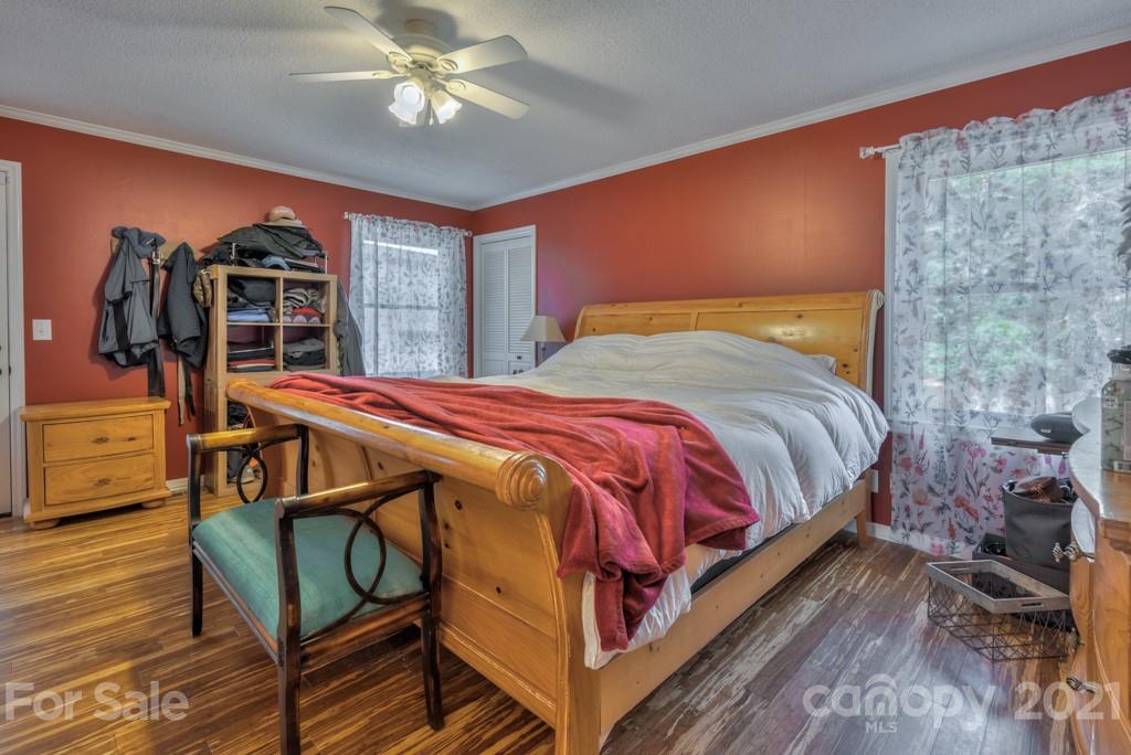 125 Mountainview Road Landrum, SC 29356 - Photo 16 of 48 a bedroom with a bed and a chandelier