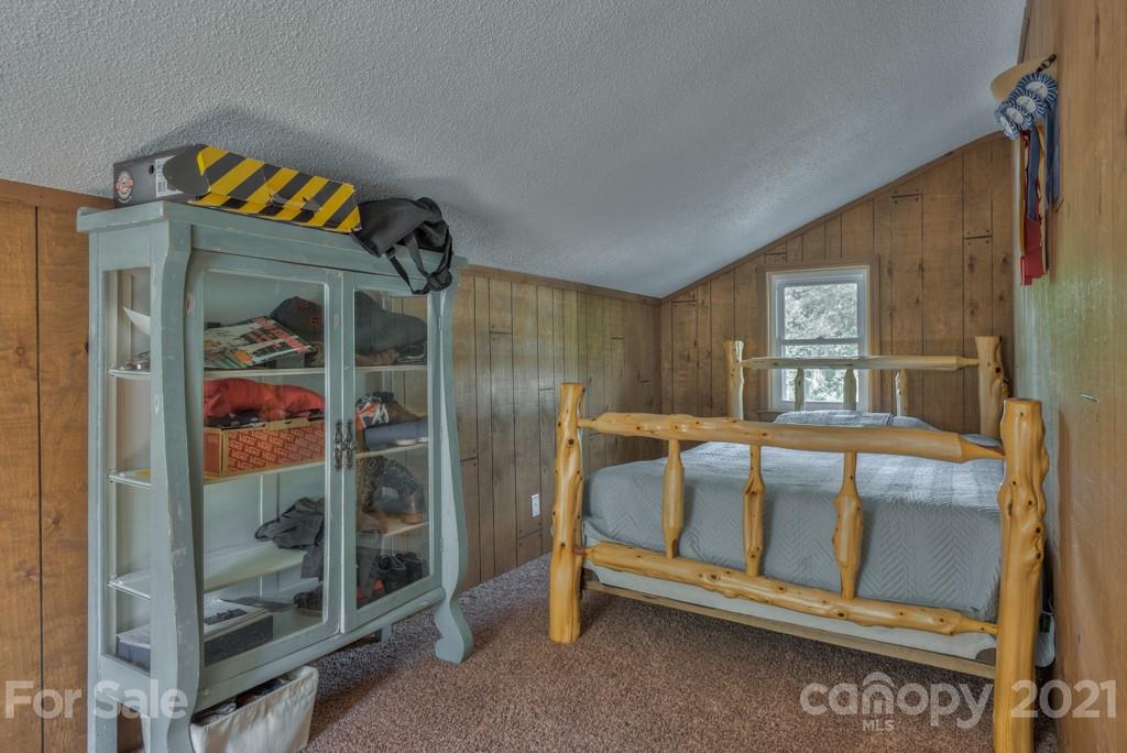 125 Mountainview Road Landrum, SC 29356 - Photo 22 of 48 a bedroom with a bed and a window