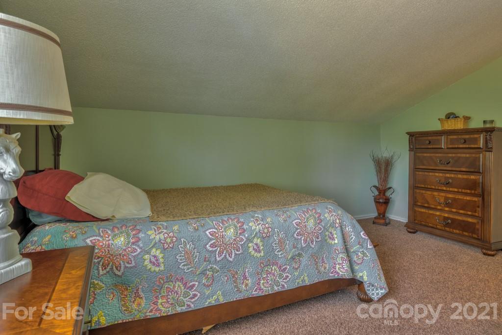 125 Mountainview Road Landrum, SC 29356 - Photo 24 of 48 a bedroom with a bed and dresser