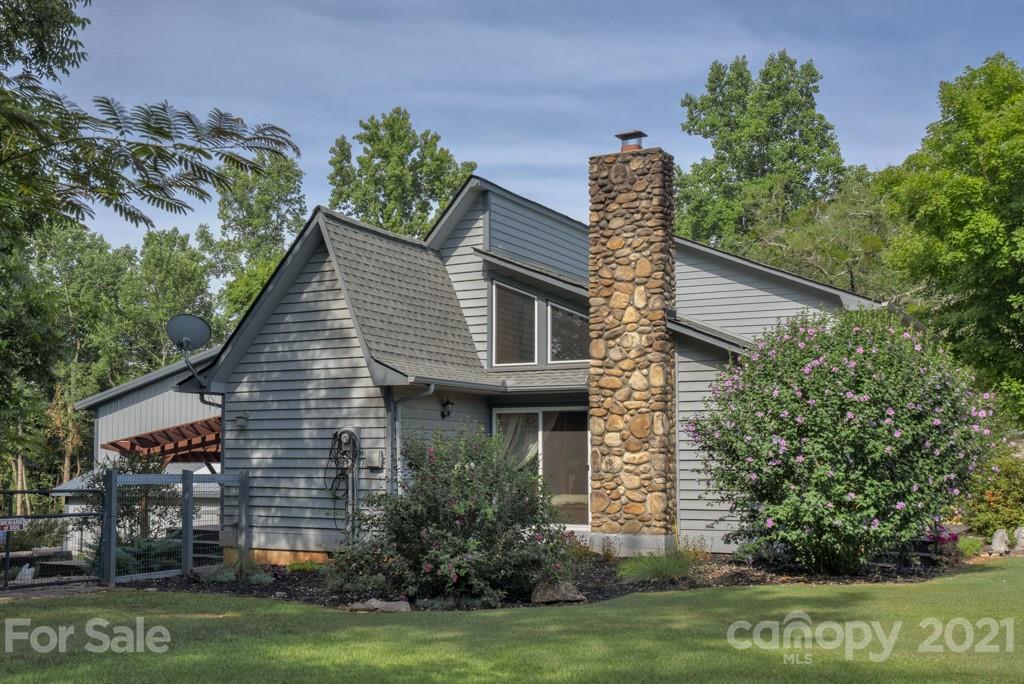 125 Mountainview Road Landrum, SC 29356 - Photo 37 of 48 a front view of a house with a garden and plants