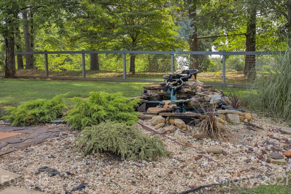 125 Mountainview Road Landrum, SC 29356 - Photo 45 of 48 a backyard of a house with table and chairs