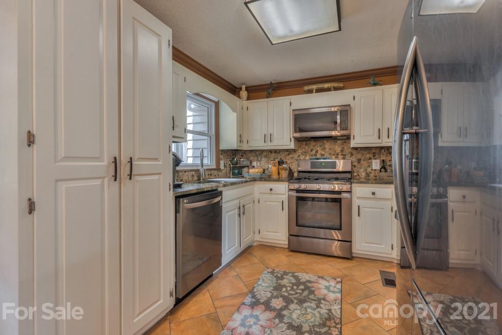 125 Mountainview Road Landrum, SC 29356 - Photo 7 of 48 a kitchen with stainless steel appliances granite countertop a stove a sink and a refrigerator