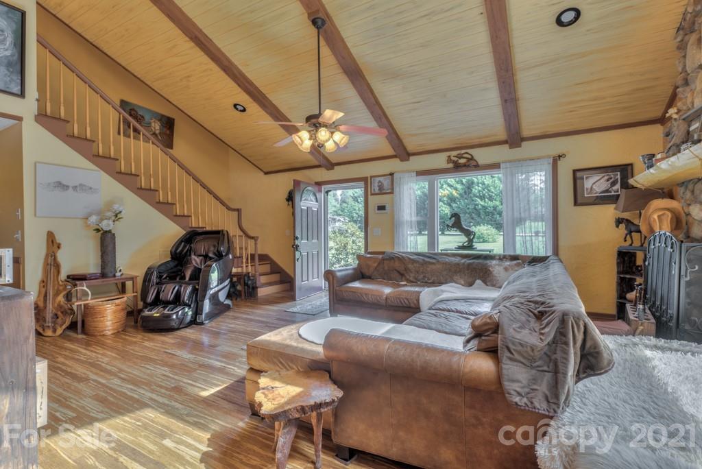 125 Mountainview Road Landrum, SC 29356 - Photo 10 of 48 a living room with furniture a window and gym equipment