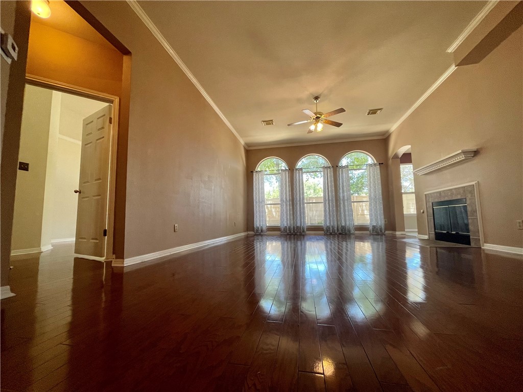 1881 Dapplegrey Lane Austin, TX 78727 - Photo 11 of 28 a view of empty room with wooden floor and fan