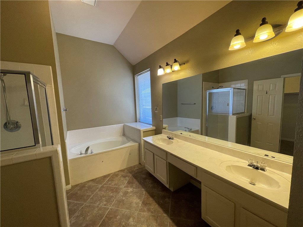 1881 Dapplegrey Lane Austin, TX 78727 - Photo 13 of 28 a bathroom with a tub sink and mirror