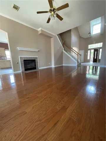 a view of a livingroom with a ceiling fan window and wooden floor