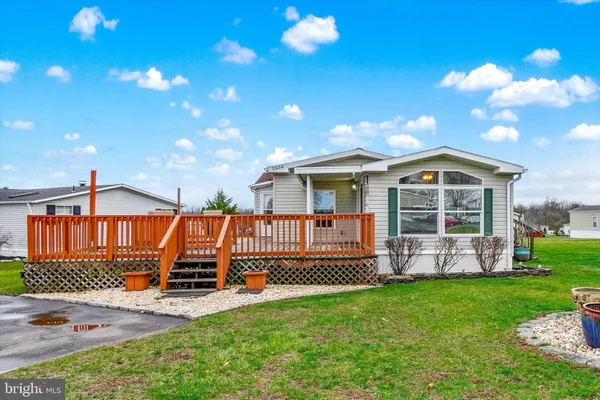 a view of a house with a yard and porch