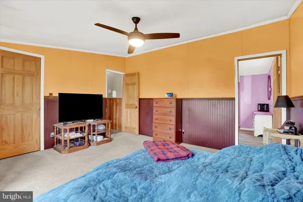 a bedroom with furniture and a flat screen tv