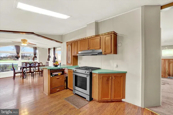 a kitchen with stainless steel appliances granite countertop wooden floors and stove