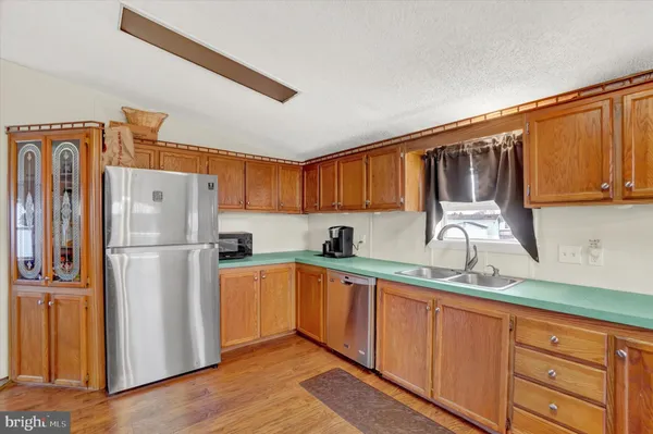 a kitchen with stainless steel appliances granite countertop a refrigerator sink and cabinets