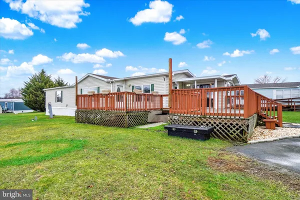 a view of a house with a yard porch and furniture