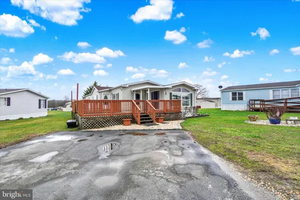 a view of a house with a yard porch and sitting area