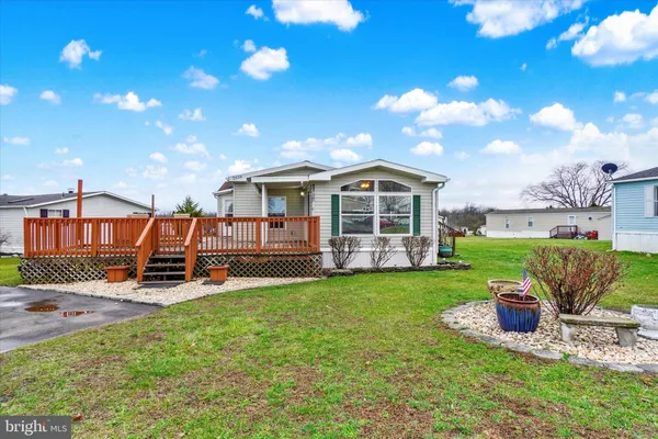 a view of a house with backyard porch and sitting area