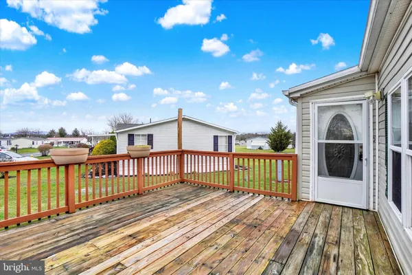 a view of a balcony with wooden floor