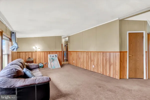 a living room with furniture and a lamp