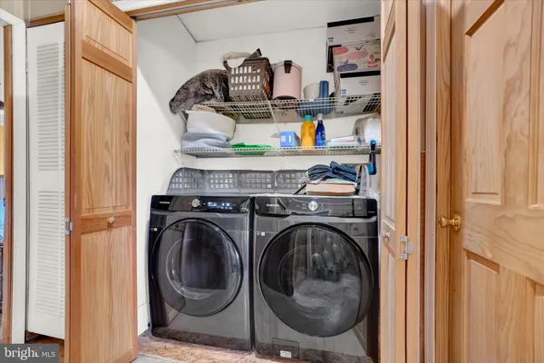 a utility room with sink dryer and washer