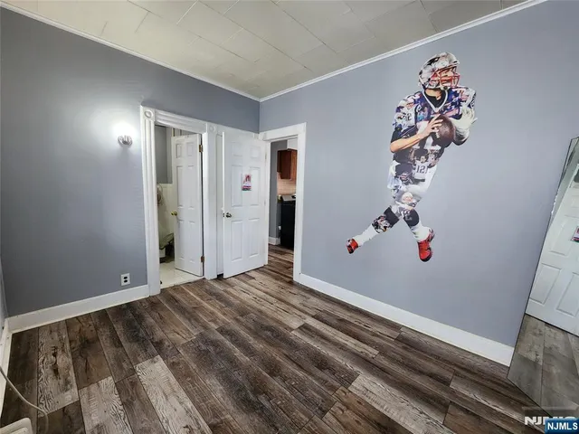 a view of a livingroom with wooden floor and entryway