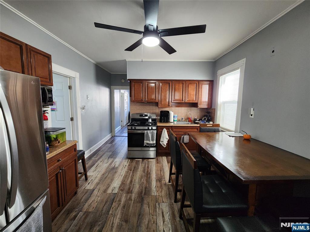 93 1st Street, Unit 1 Clifton, NJ 07011 - Photo 2 of 8 a kitchen with granite countertop a refrigerator a sink dishwasher a stove and white countertops with wooden floor
