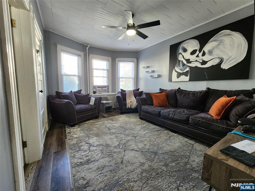 93 1st Street, Unit 1 Clifton, NJ 07011 - Photo 3 of 8 a living room with furniture and a window