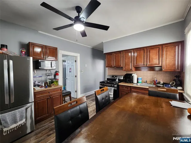 a kitchen with stainless steel appliances granite countertop a refrigerator stove top oven a sink and dishwasher