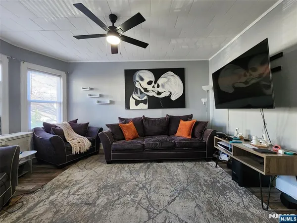 a living room with furniture and a flat screen tv
