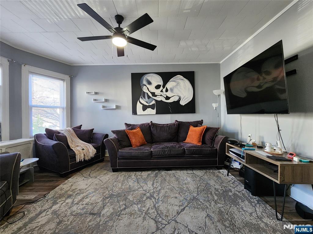 93 1st Street, Unit 1 Clifton, NJ 07011 - Photo 6 of 8 a living room with furniture and a flat screen tv