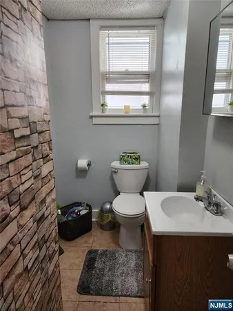 a bathroom with a toilet a sink and a window