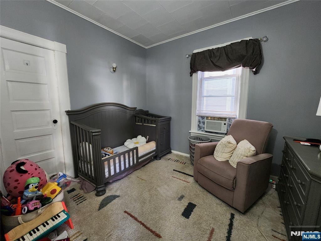 93 1st Street, Unit 1 Clifton, NJ 07011 - Photo 8 of 8 a living room with furniture and a baby crib