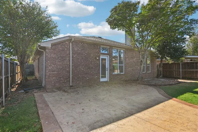 a view of a backyard with a large tree