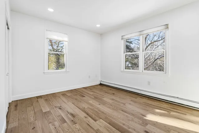 an empty room with a painting on the wall