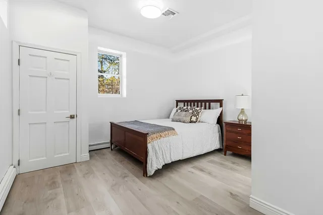 a bedroom with a bed and a table