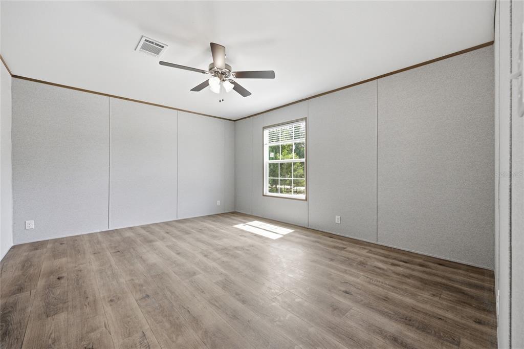 150 19th Street Interlachen, FL 32148 - Photo 14 of 30 wooden floor in an empty room with a window