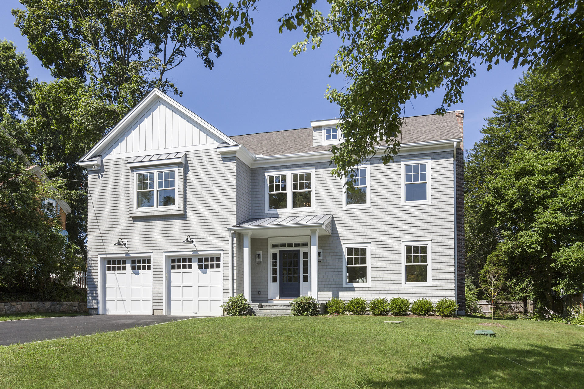8 Walmsley Road Darien, CT 06820 - Photo 1 of 28 a front view of a house with a yard and trees