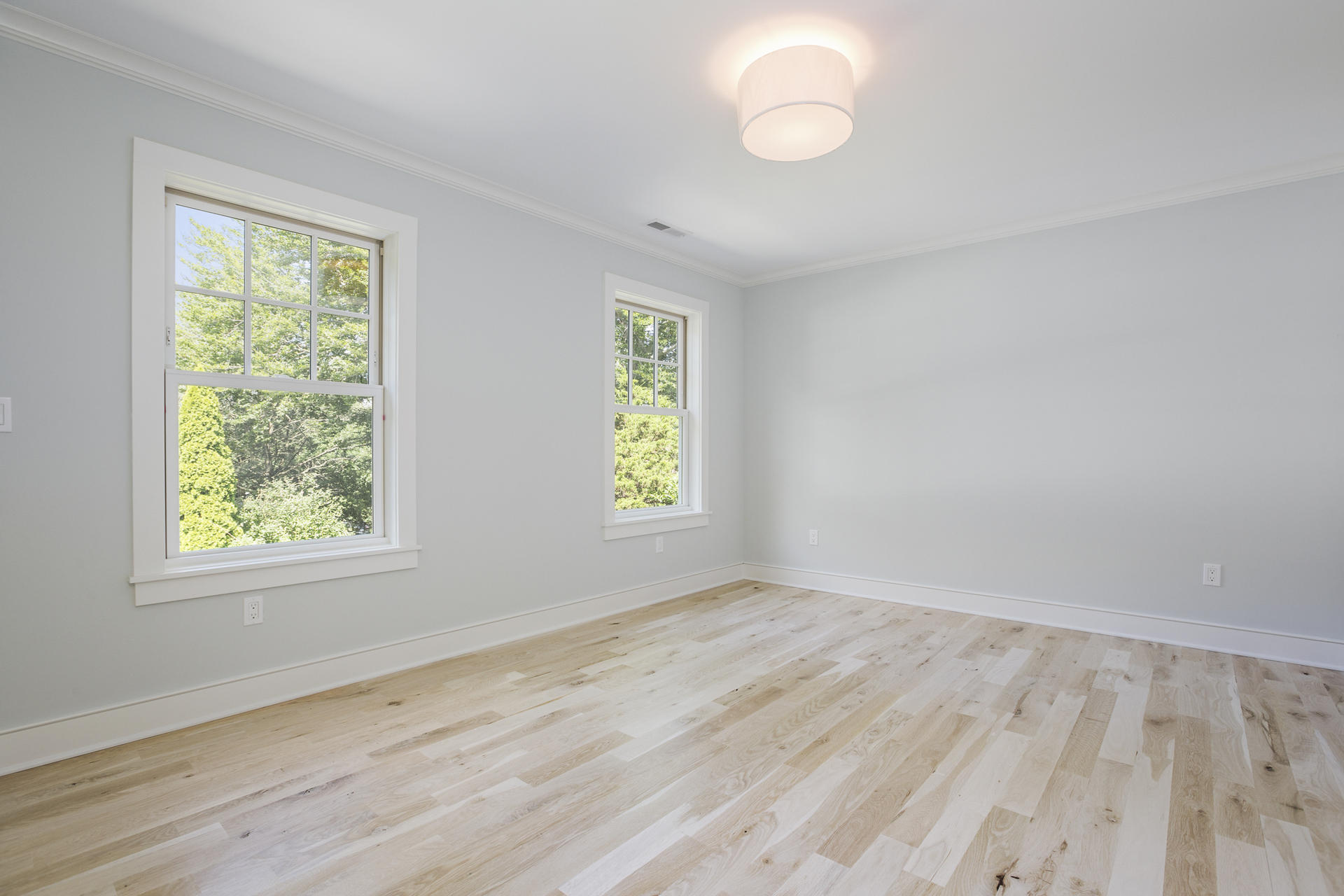 8 Walmsley Road Darien, CT 06820 - Photo 19 of 28 a view of an empty room with wooden floor and a window