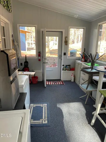 a view of kitchen with furniture and wooden floor