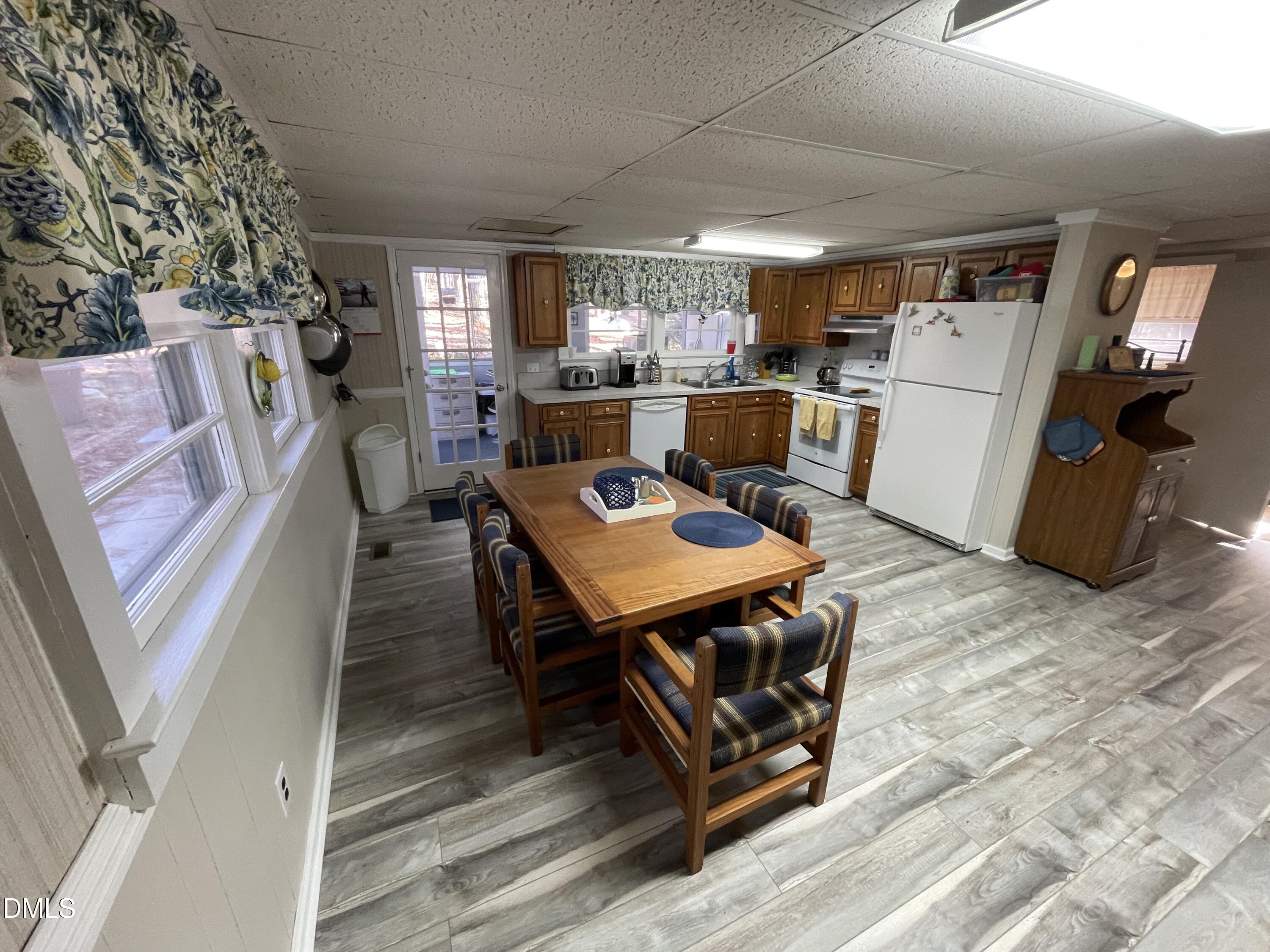 129 Boulder Boulevard Manson, NC 27553 - Photo 19 of 43 a living room with furniture and a dining table with kitchen view