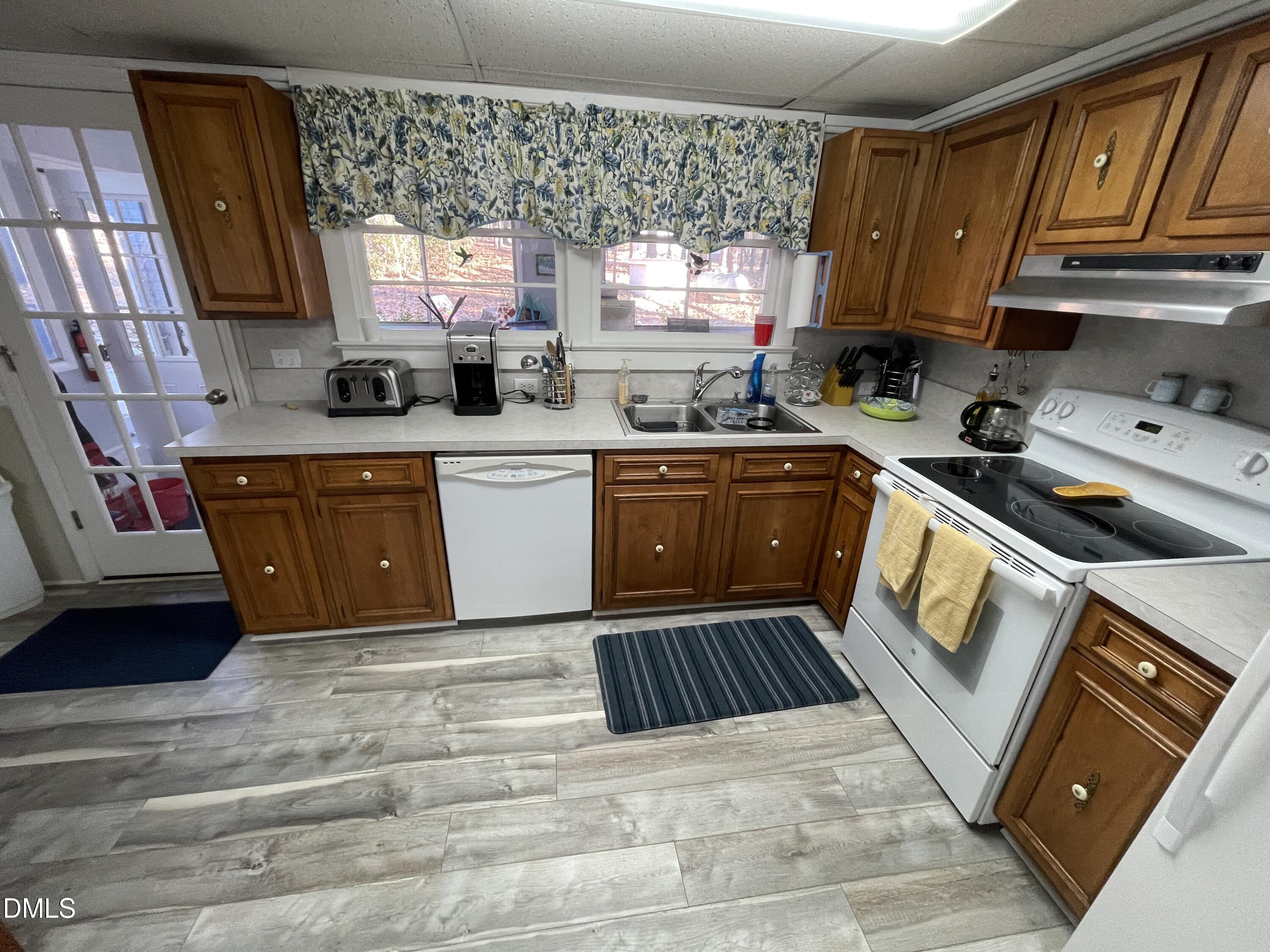 129 Boulder Boulevard Manson, NC 27553 - Photo 21 of 43 a kitchen with stainless steel appliances granite countertop a sink stove and cabinets