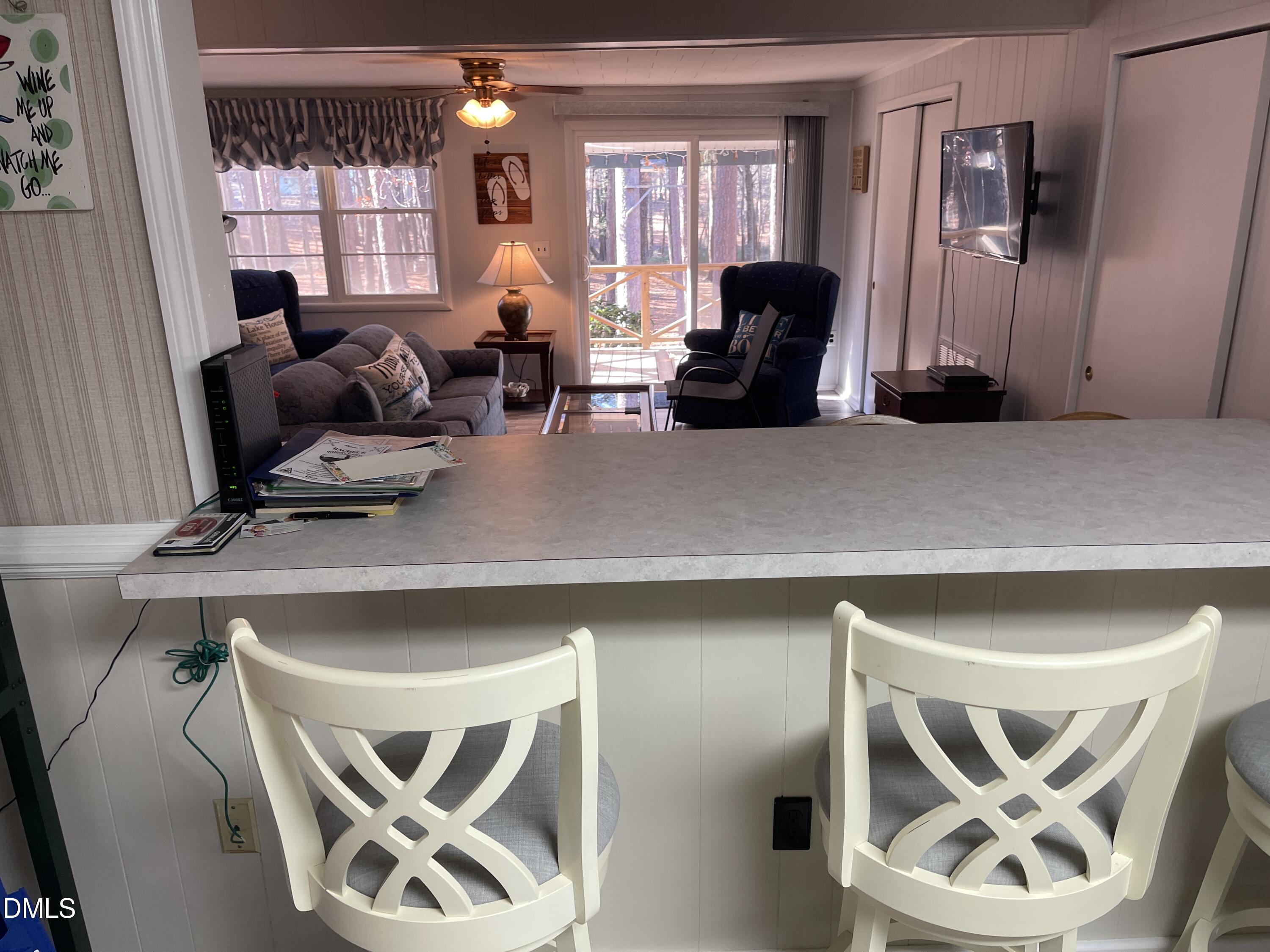129 Boulder Boulevard Manson, NC 27553 - Photo 22 of 43 a living room with furniture a window and gym equipment